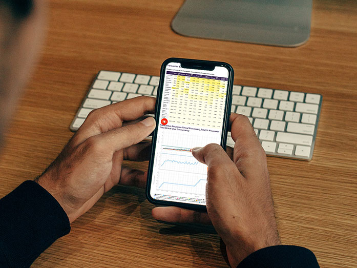 Eggplant displayed on the screen of a mobile phone, cradled in a pair of hands.