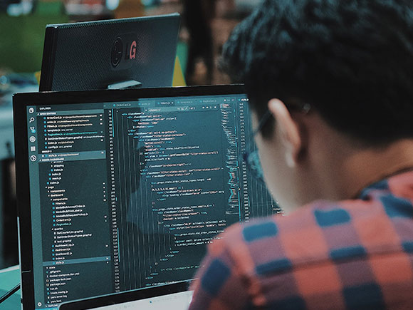 Developer viewing code on a computer screen.