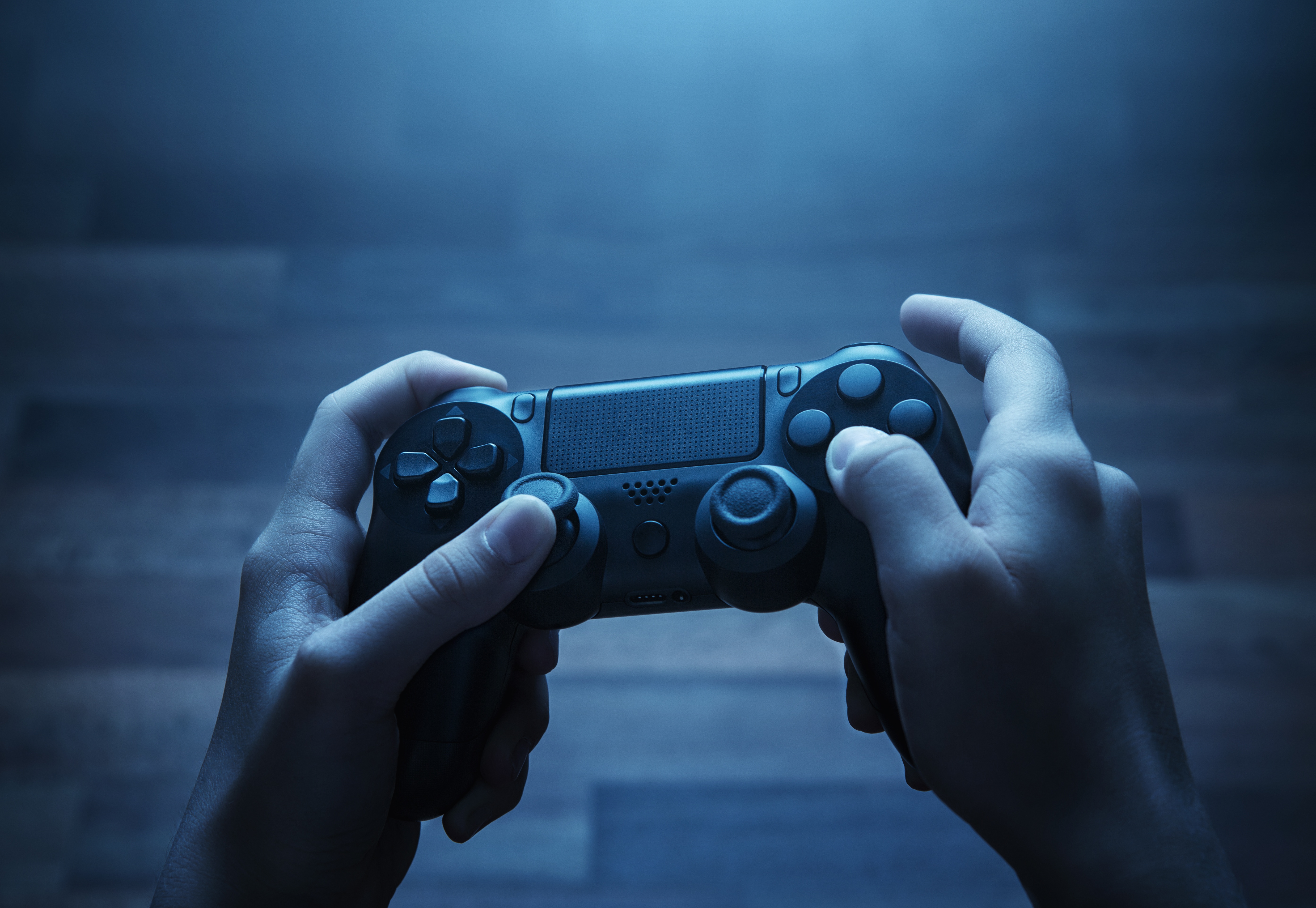 Close-up of a pair of hands holding a gaming console.